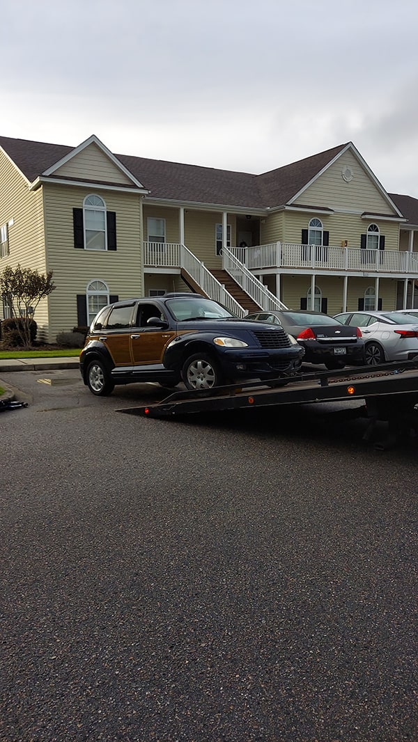 car being pulled onto the flat bed of tow truck