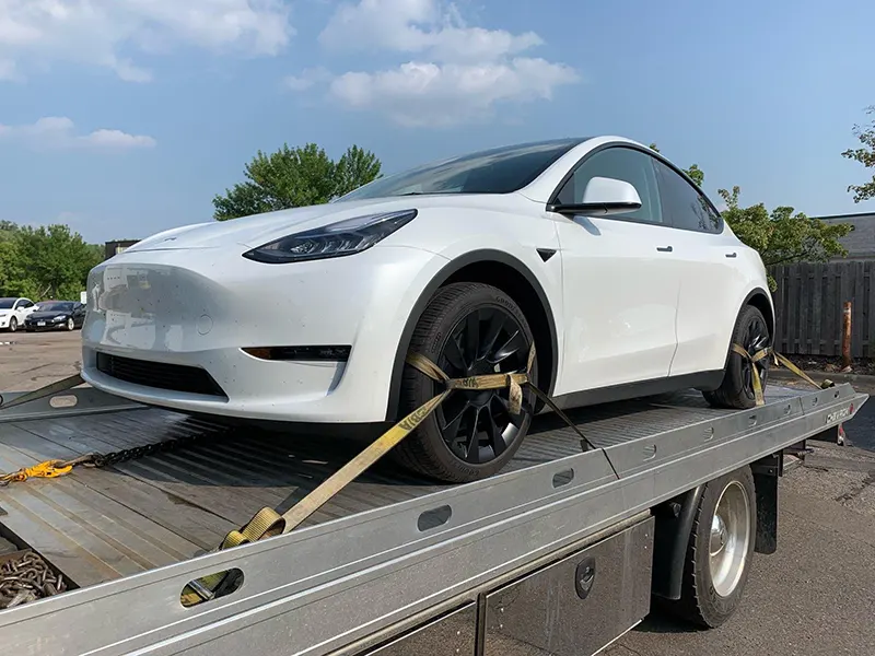 888 Tows towing a tesla on a flatbed truck